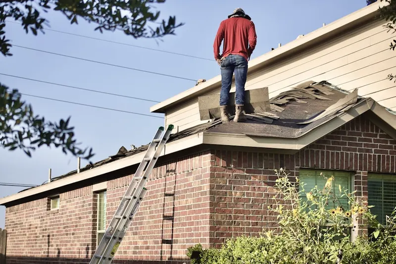 Professional roofer working on a residential roof in Aquia Creek
